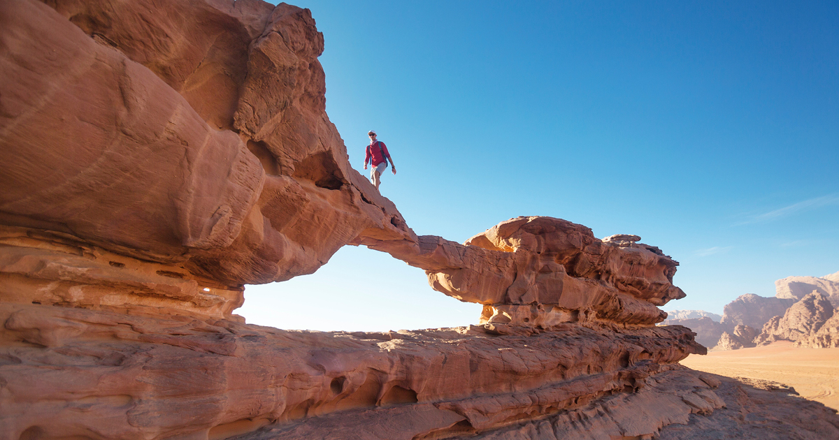 Man crossing a rock